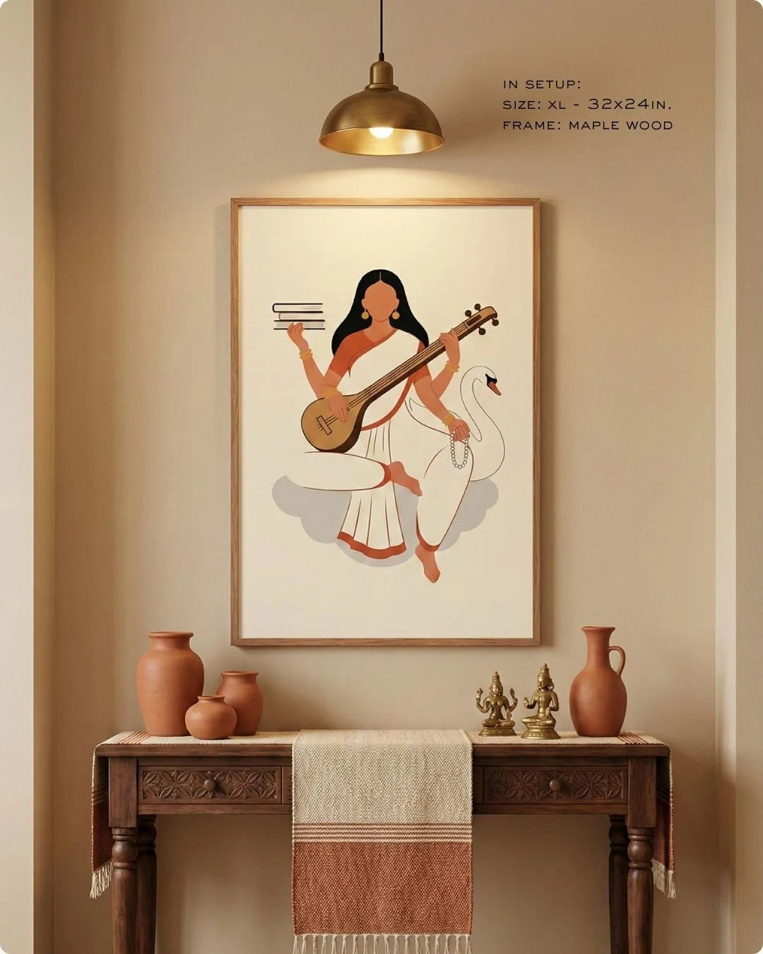Goddess Saraswati divine illustration in a Maple Wood frame, styled over a modern wooden console with earthy pottery and a warm pendant light.