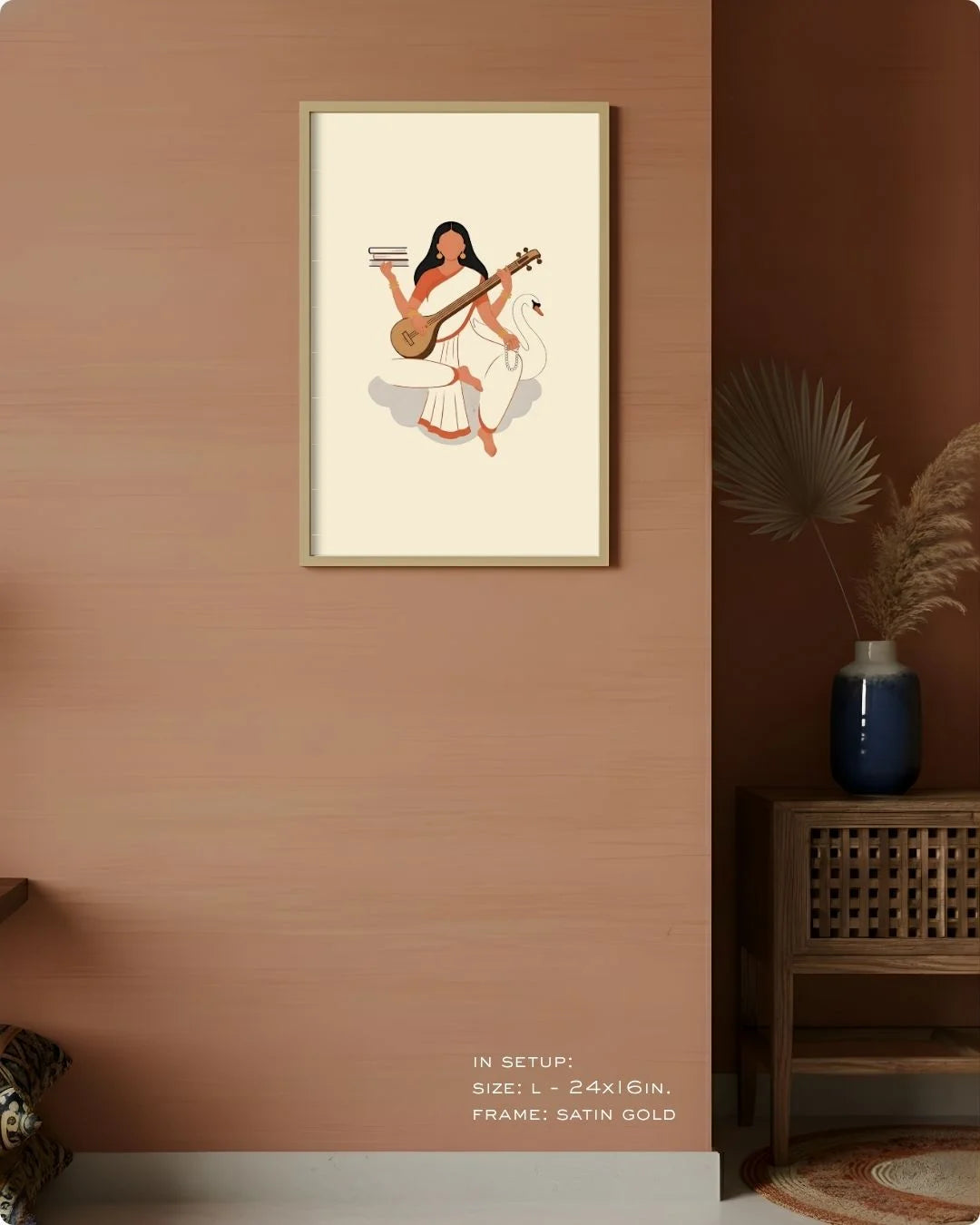 Medium (Size M - 18x12in) Goddess Saraswati minimalist art in a Satin Gold frame, showing scale on a warm earthy neutral wall.