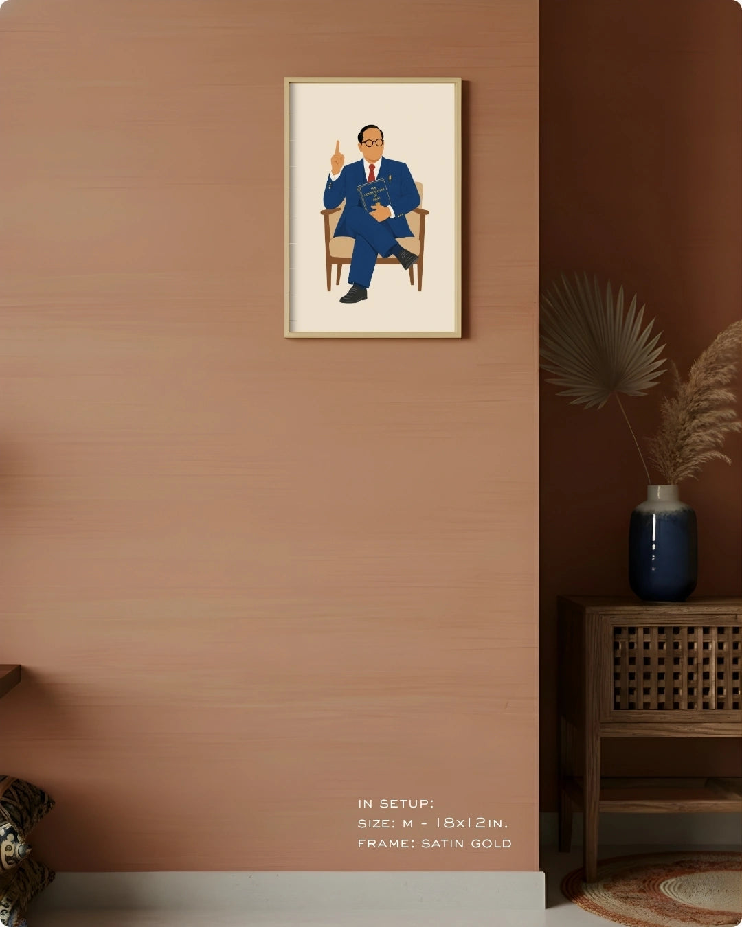 Visual size guide mockup for the seated Dr. B.R. Ambedkar wall art in Medium size with a satin gold frame displayed against a warm terracotta accent wall.