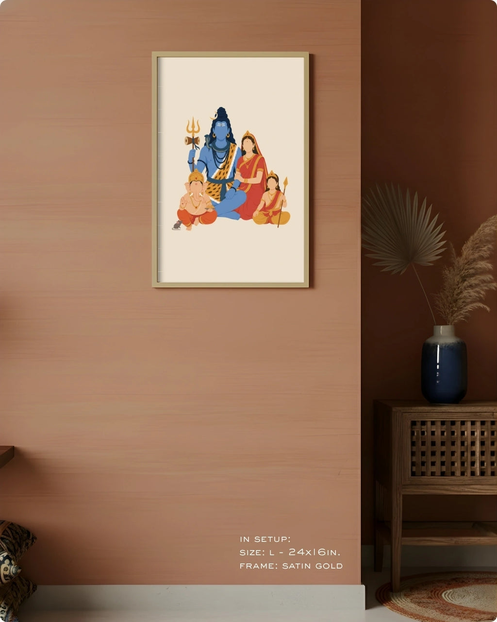 A framed art print depicting the Hindu family of Krishna, styled on a textured terracotta wall in a home decor setting next to a wooden side table and vase.