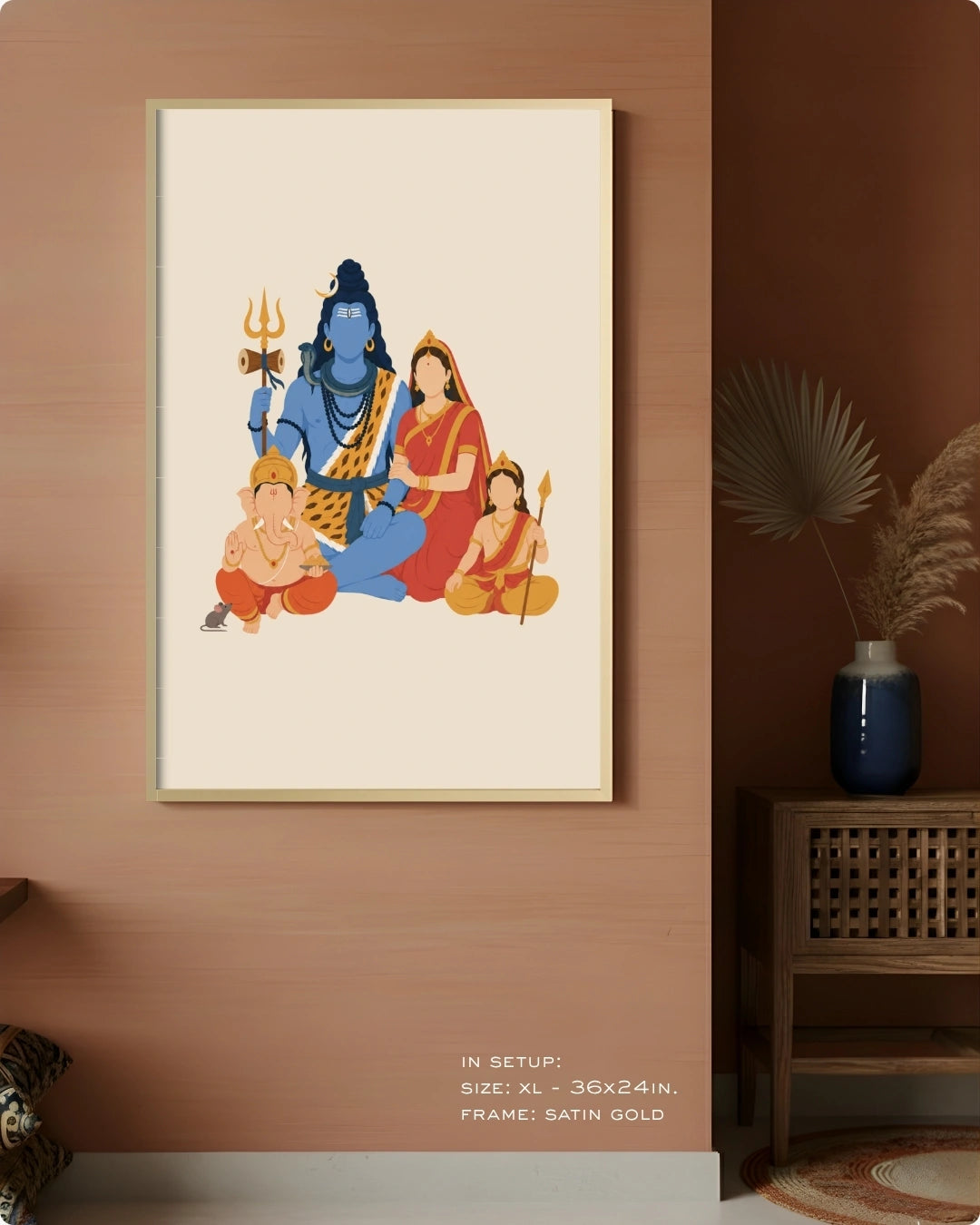 A framed art print featuring a stylized illustration of Hindu deities, including blue Shiva and red and gold figures, displayed on a warm brown wall in a styled interior setting.