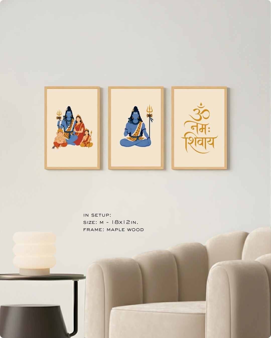Visual size guide mockup for the Shiv Parivar Triad 3-piece wall art set in Medium size with satin gold frames, displayed above a modern ribbed beige armchair.