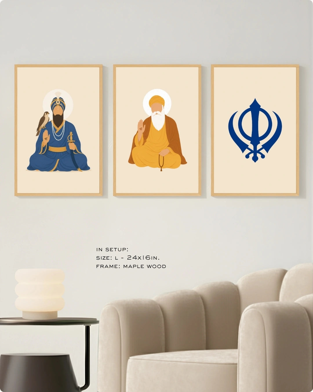 Visual size guide mockup for the Sikh Triad 3-piece wall art set in Large size with satin gold frames, displayed above a modern ribbed beige armchair.