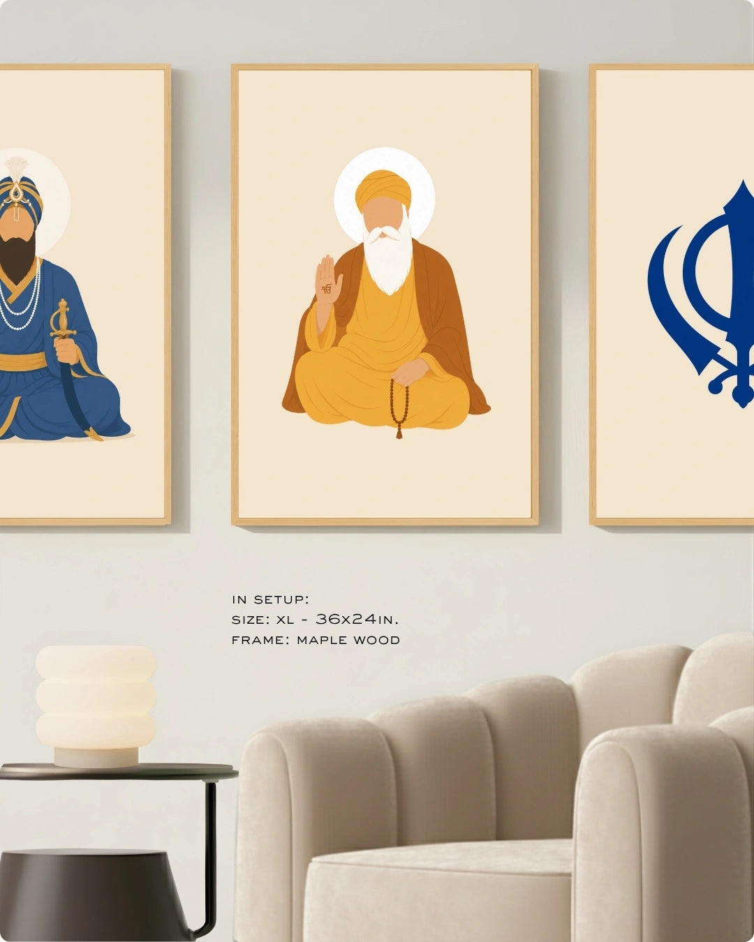 Visual size guide mockup for the Sikh Triad 3-piece wall art set in Extra Large size with satin gold frames, displayed above a modern ribbed beige armchair.