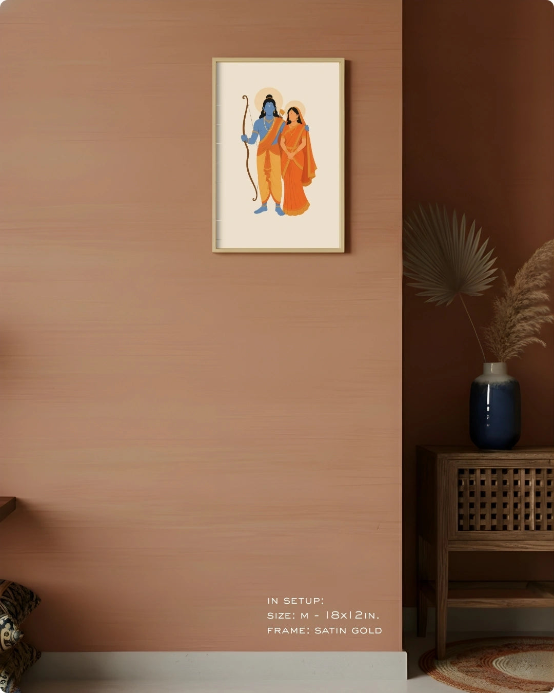 Visual size guide mockup for the Hindu divine couple Sita and Rama wall art in Medium size with a satin gold frame, displayed against a warm terracotta accent wall.