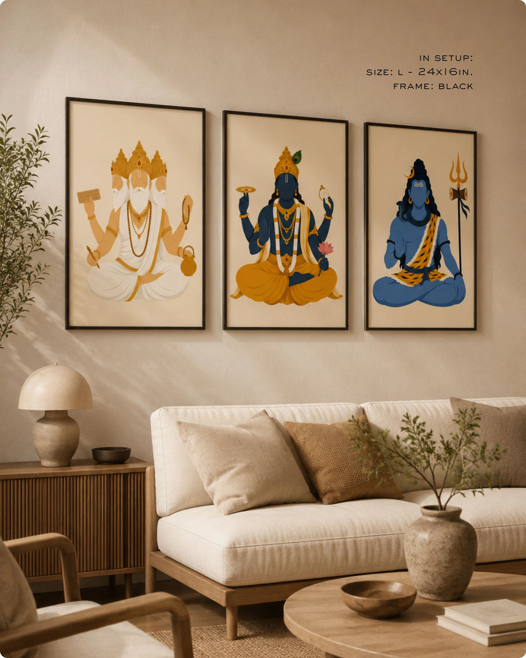 Lifestyle interior mockup of the Hindu Trimurti wall art set of 3, featuring Brahma, Vishnu, and Shiva in size Large (24x16 inches) with sleek black frames, styled above a warm beige living room sofa.