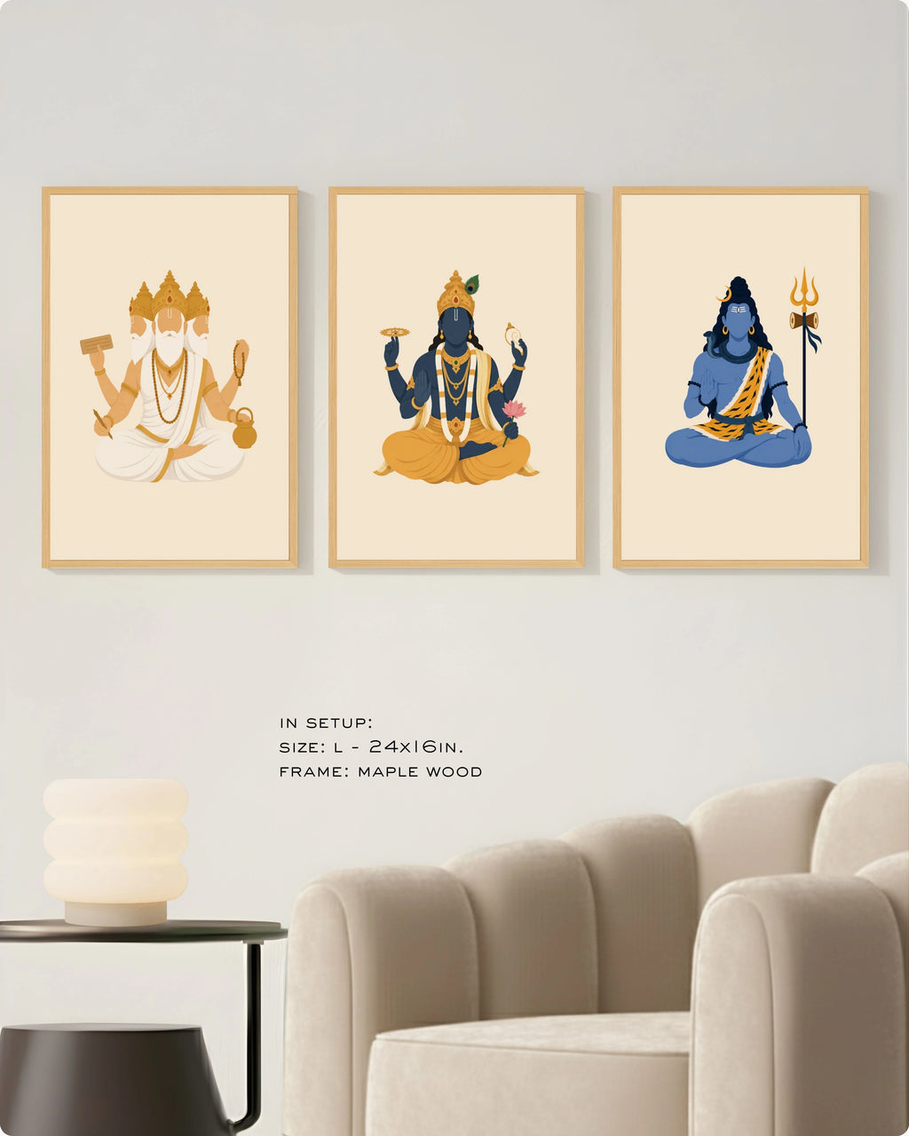 Visual size guide mockup for the Hindu Trimurti wall art set of 3 in size Large (24x16 inches) with maple wood frames, shown scaled perfectly next to a contemporary beige armchair.