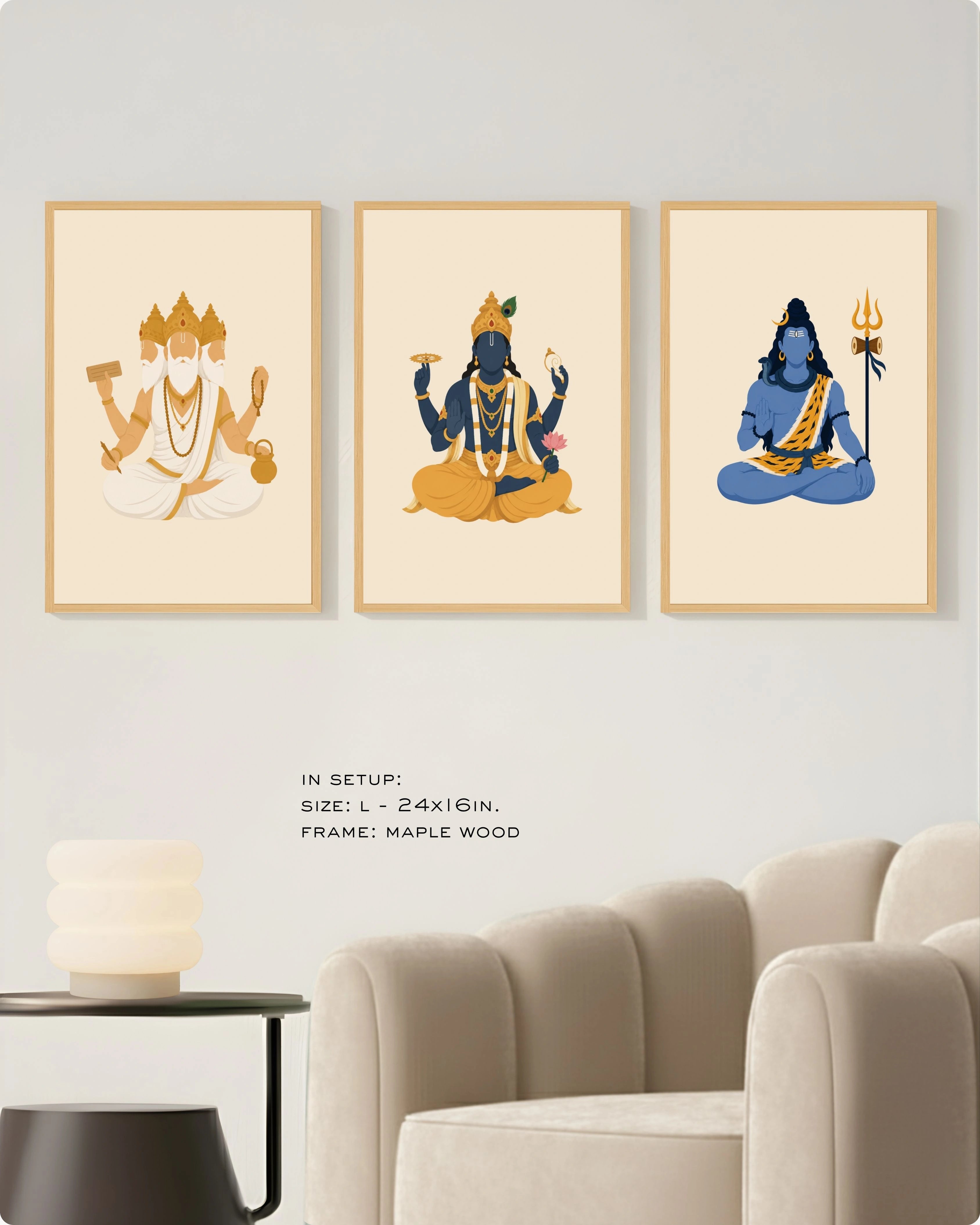 Visual size guide mockup for the Hindu Trimurti wall art set of 3 in size Large (24x16 inches) with maple wood frames, shown scaled perfectly next to a contemporary beige armchair.