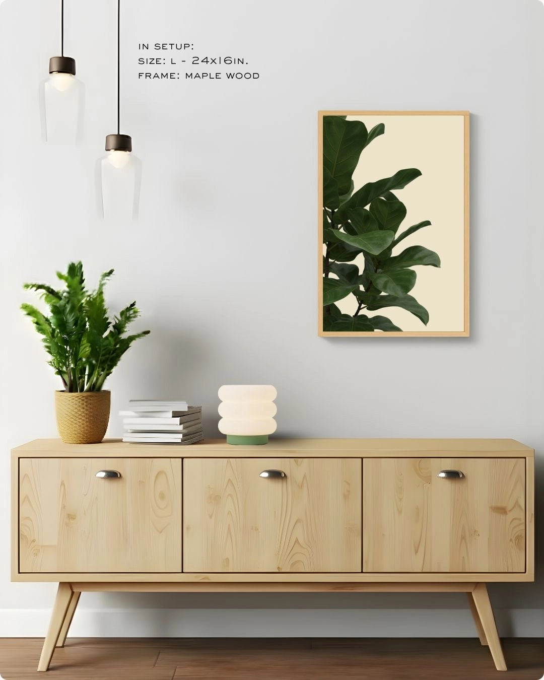Minimalist Fiddle Leaf Fig wall art by K2C Co. in a Maple Wood frame (Size L), styled in a bright Japandi home mockup above a wooden sideboard with pendant lighting.