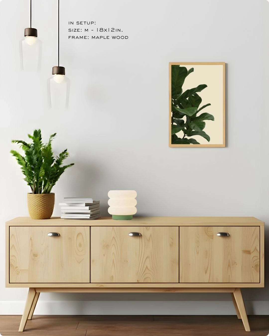Medium-sized (Size M) Fiddle Leaf Fig botanical print by K2C Co. in a Maple Wood frame, displayed in a clean living room setting to showcase versatile wall decor scaling.