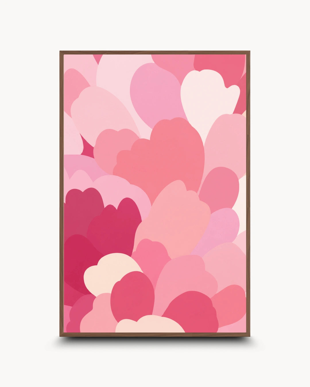A framed art print featuring a modern pattern of overlapping hearts in various shades of pink, magenta, and light cream, set against a clean off-white background.