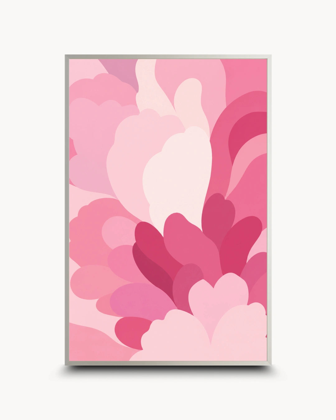A framed abstract art print featuring layered, organic pink shapes in various shades of light, medium, and deep pink, set against a clean off-white background.