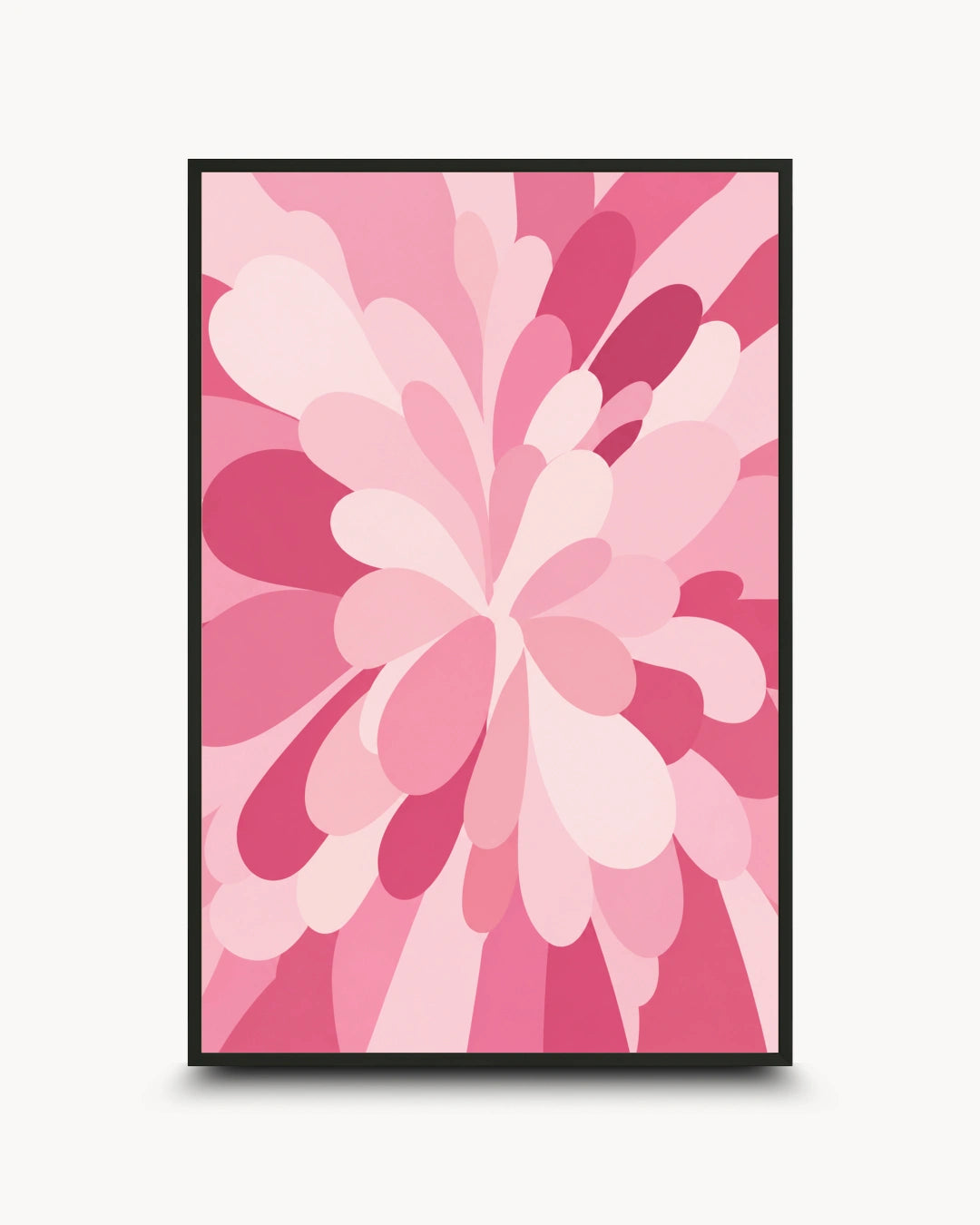A framed abstract floral art print featuring layered pink and magenta petal-like shapes on a light background, shown against a plain light gray wall.