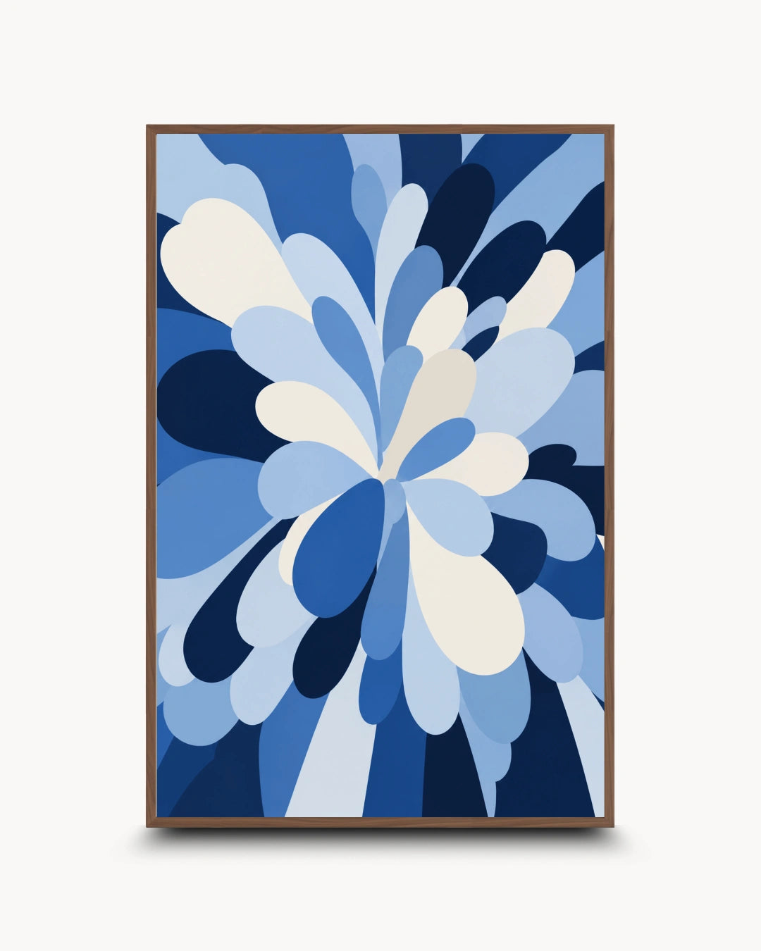 A framed abstract art print featuring a stylized floral burst in shades of blue, navy, light blue, and cream, set against a light gray background.
