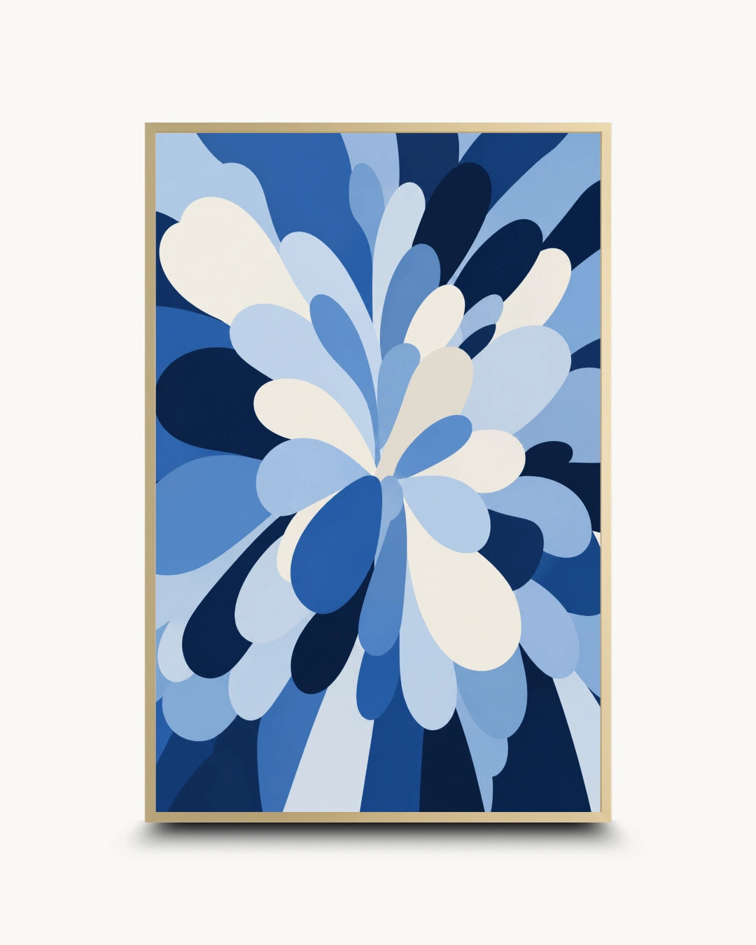 A framed abstract floral art print featuring layered blue and white petal-like shapes, enclosed in a thin gold frame against a light gray background.