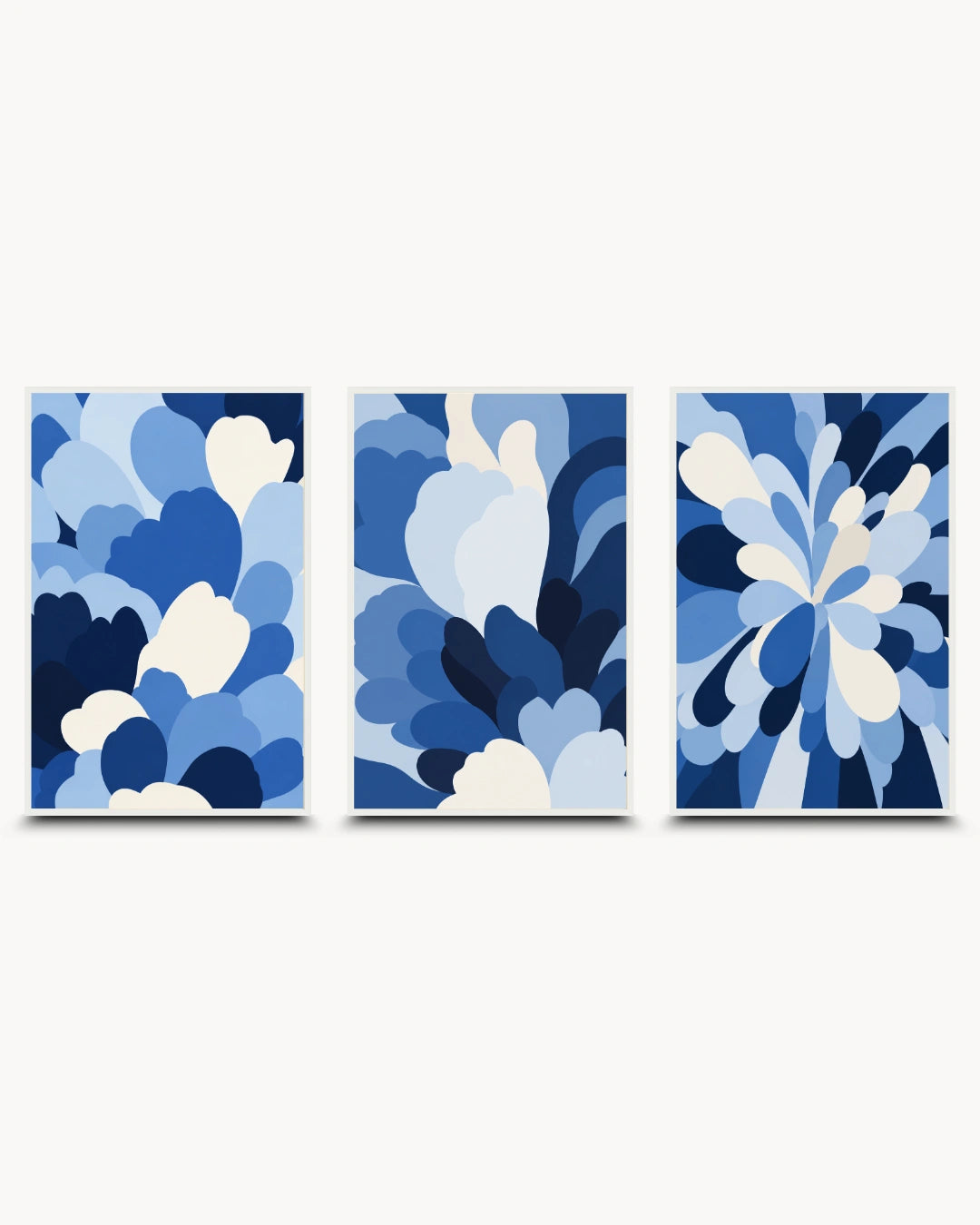A three-panel abstract wall art set featuring layered floral or petal-like shapes in shades of blue and white on a light gray background.
