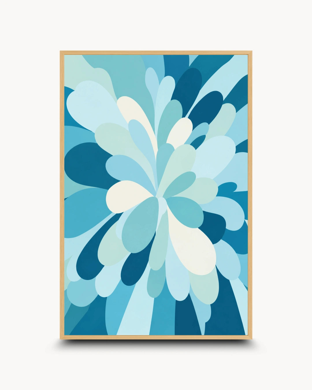 A framed abstract floral art print featuring layered petal-like shapes in shades of blue, teal, and white, enclosed in a light wood frame against a clean off-white background.