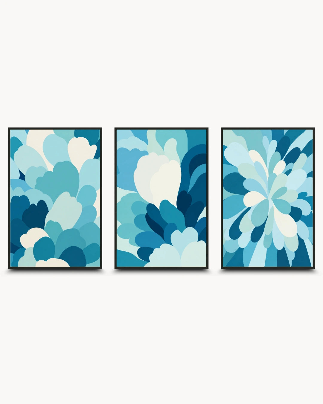 Three framed abstract wall art prints with layered petal-like shapes in shades of blue, teal, and white, displayed side by side against a light gray background.