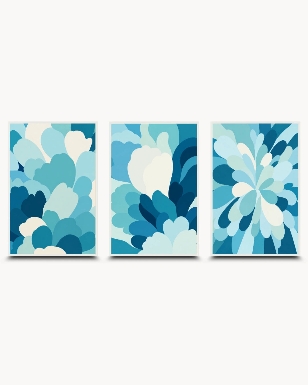 A set of three vertical abstract wall art panels with layered petal-like shapes in shades of blue, teal, and white, shown against a light gray background.