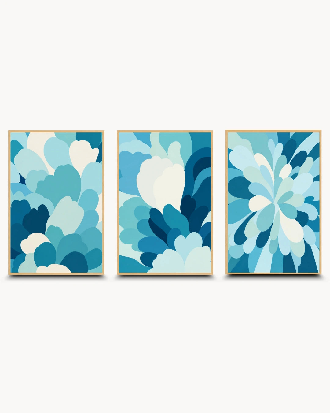 A set of three vertical abstract wall art panels with layered petal-like shapes in shades of blue, teal, and white, shown against a light gray background.