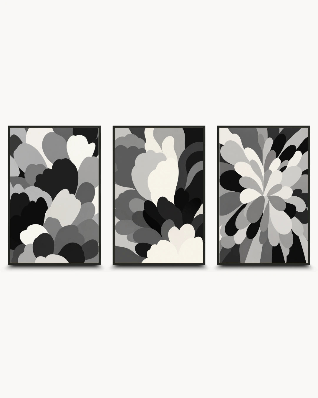 Three framed abstract wall art prints in a black, white, and gray color scheme, arranged side-by-side against a light gray background.