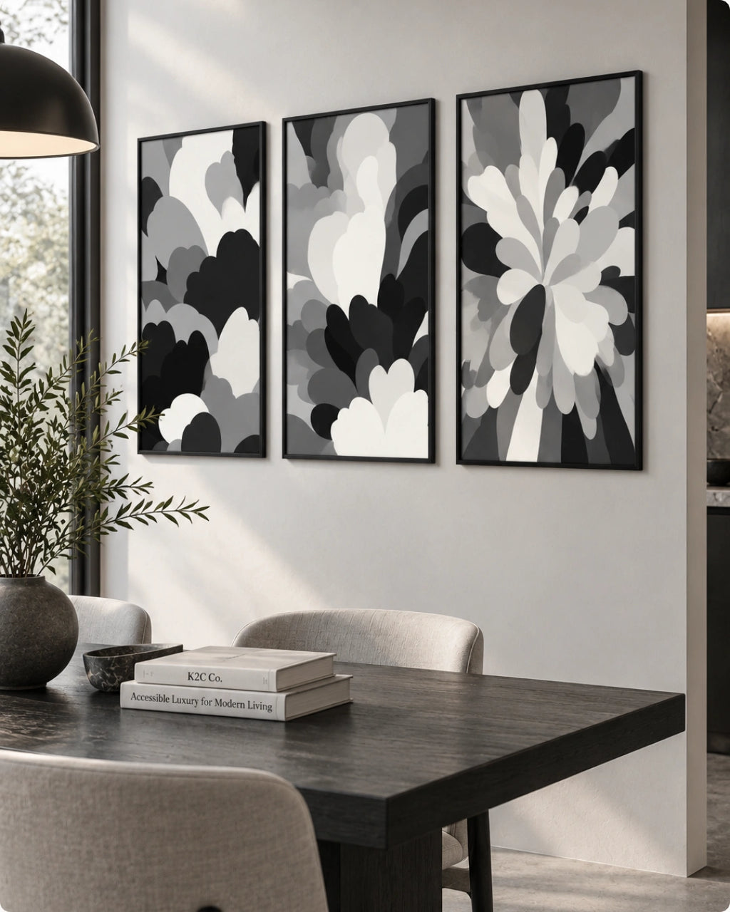 Three framed abstract black, white, and gray floral wall art prints displayed above a dark wood dining table in a modern dining room setting.