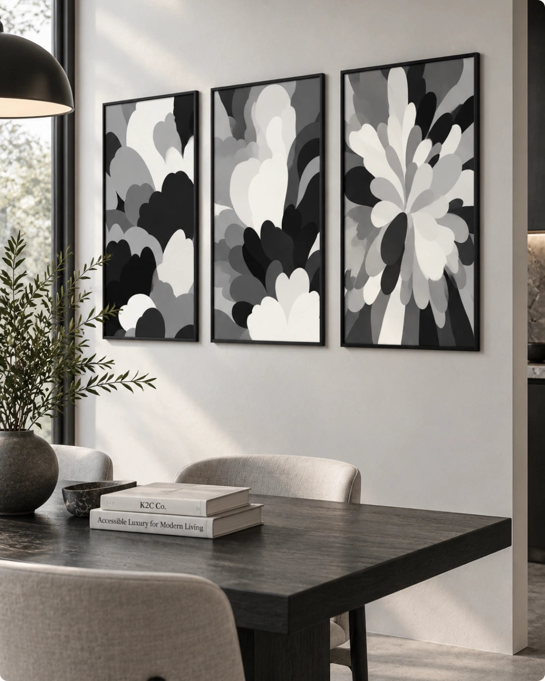 Three framed abstract black, white, and gray floral wall art prints displayed above a dark wood dining table in a modern dining room setting.