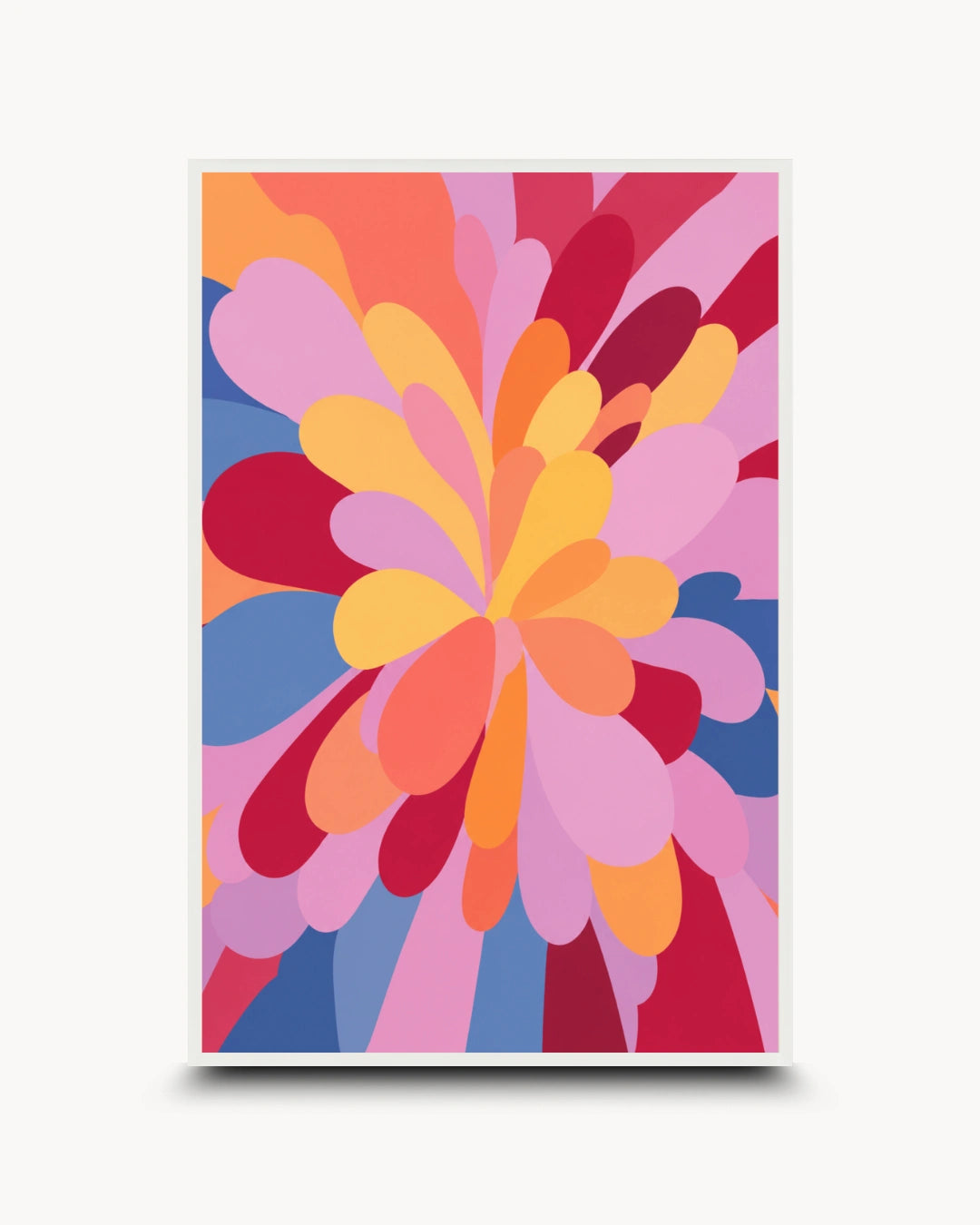 A framed abstract art print featuring a vibrant, retro-style floral burst with layered petal shapes in pink, orange, yellow, red, and blue on a light gray background.