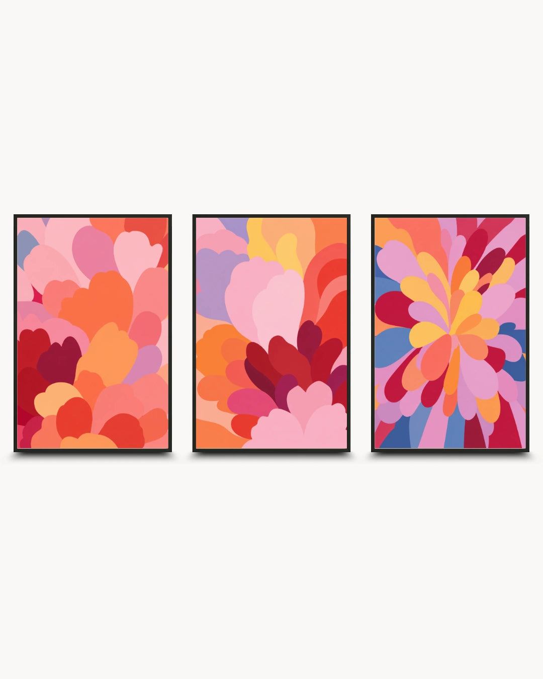 A three-piece framed wall art set featuring abstract floral and petal-like designs in warm and bright colors, displayed against a light gray background.