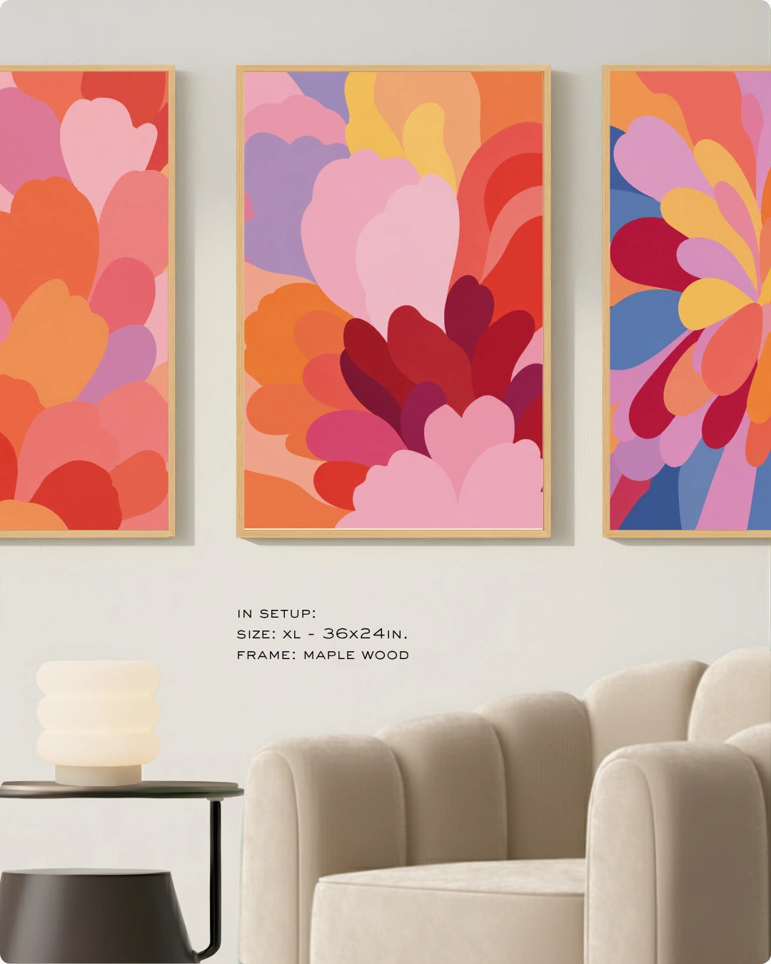 Three framed abstract floral wall art prints in warm retro colors hang on a light wall above a cream sofa, with small text noting size and maple wood frame.