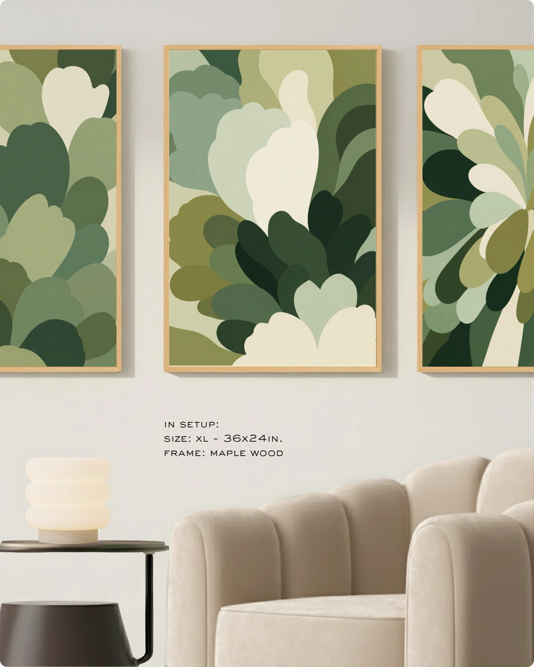 Three framed abstract botanical wall art prints in shades of green and cream hang above a beige armchair in a styled living room. Text in the lower center reads: 'IN SETUP: SIZE: XL - 36x24in.