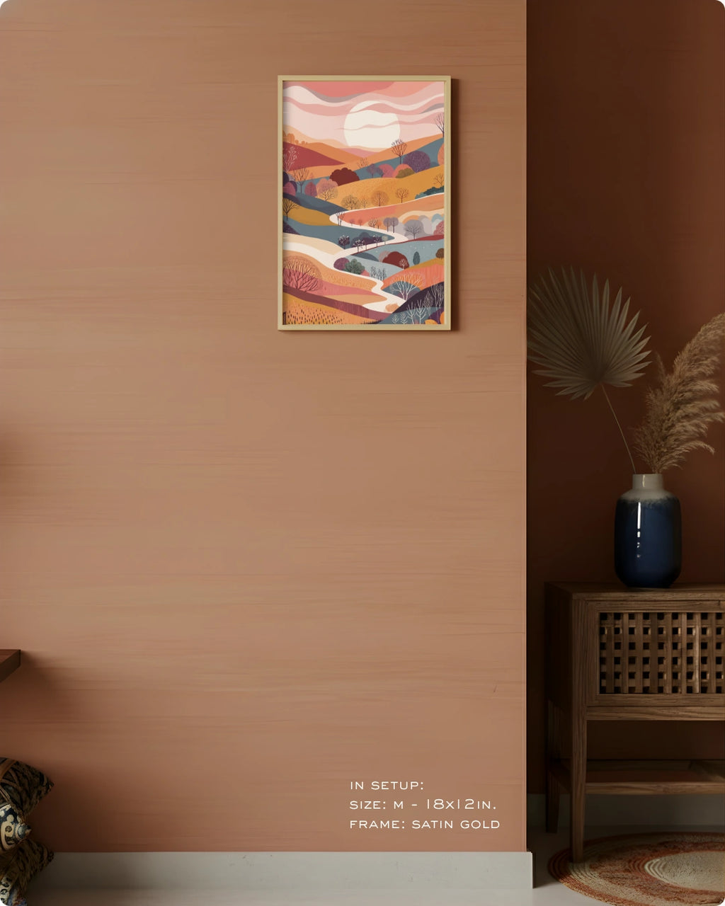 Visual size guide mockup for the Terra 1 landscape wall art in Medium size with a Satin Gold frame displayed over a woven cabinet against a terracotta wall.