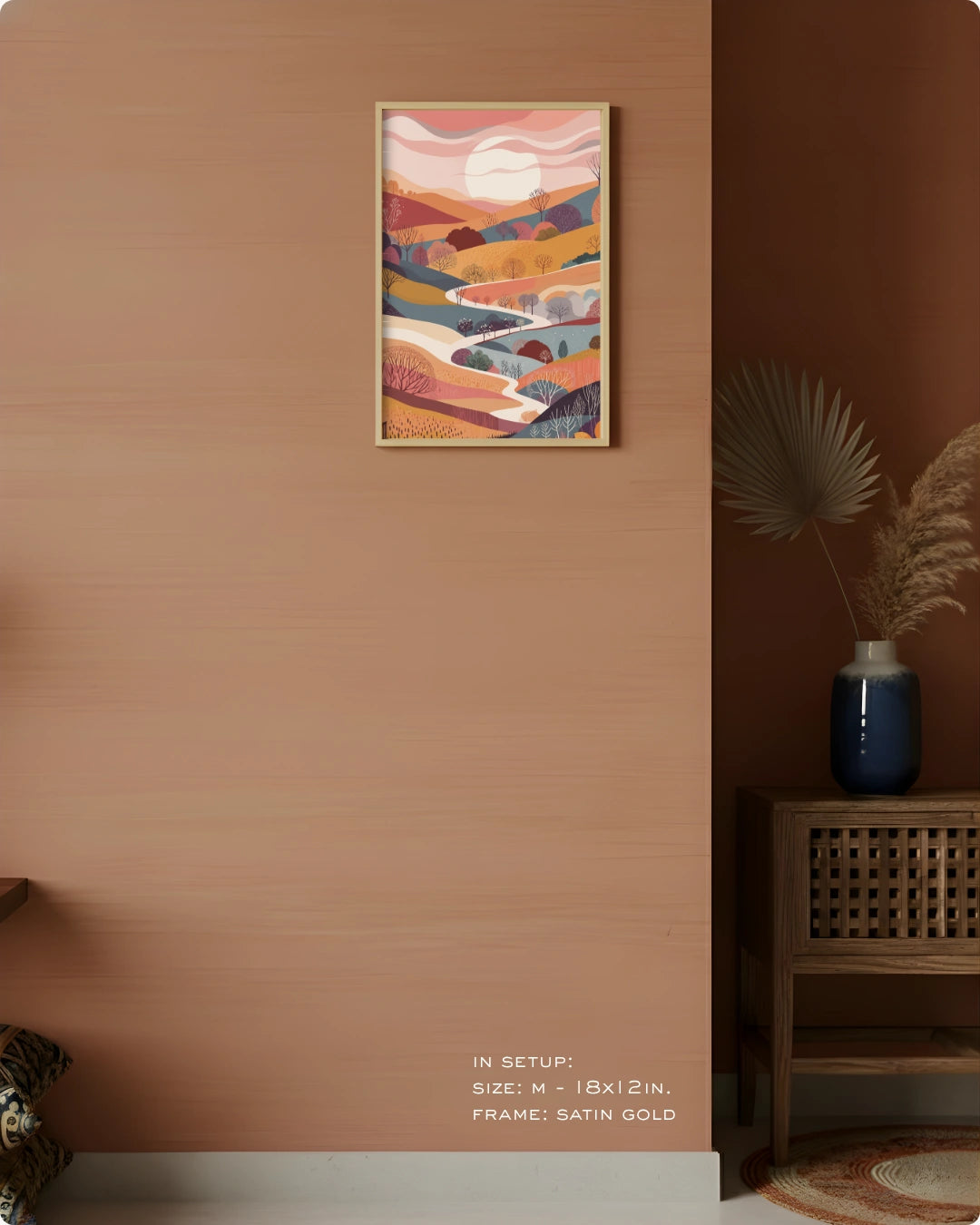 Visual size guide mockup for the Terra 1 landscape wall art in Medium size with a Satin Gold frame displayed over a woven cabinet against a terracotta wall.