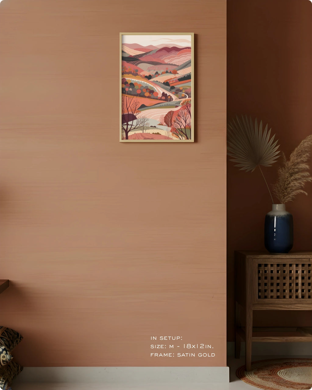 Visual size guide mockup for the Terra 3 landscape wall art in Medium size with a Satin Gold frame displayed over a woven cabinet against a terracotta wall.