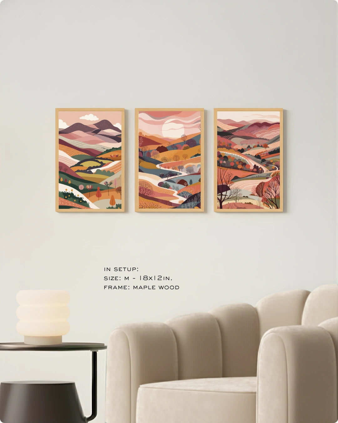 Lifestyle mockup of the Terra Collection landscape wall art triptych in Maple Wood frames displayed above a modern white curved sofa with a round coffee table.