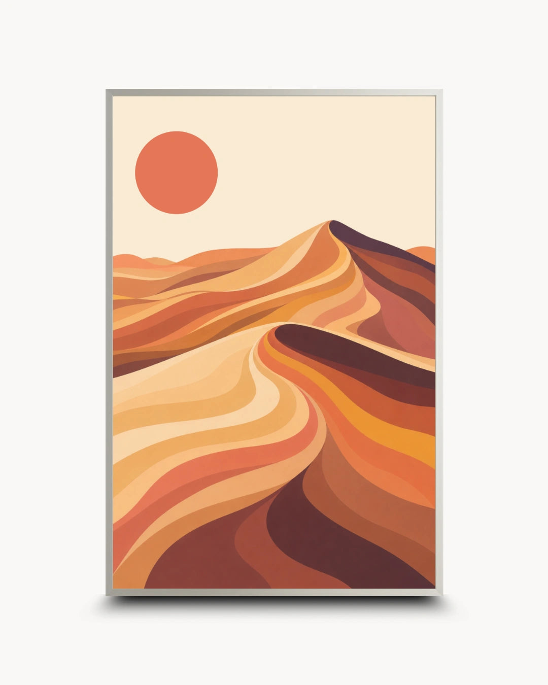 A framed art print featuring a stylized desert landscape with layered sand dunes in warm orange, brown, and beige tones under a solid orange sun, shown on a light gray background.