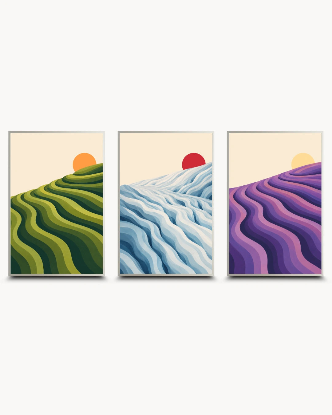 A set of three framed vertical art prints showing stylized wavy landscape fields in green, blue, and purple with sun motifs, displayed side by side on a light gray wall.