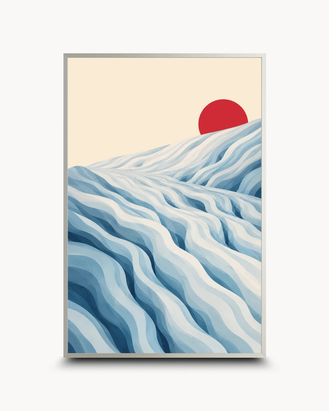 A framed art print featuring a stylized landscape with layered blue and white waves or dunes under a pale cream sky and a red sun, shown against a light gray background.