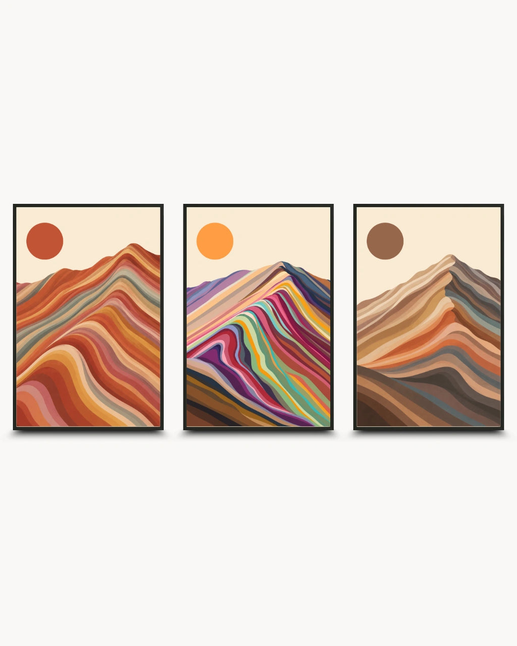 A three-piece framed wall art set featuring abstract mountain designs with colorful wavy stripes and sun motifs on a light cream background.
