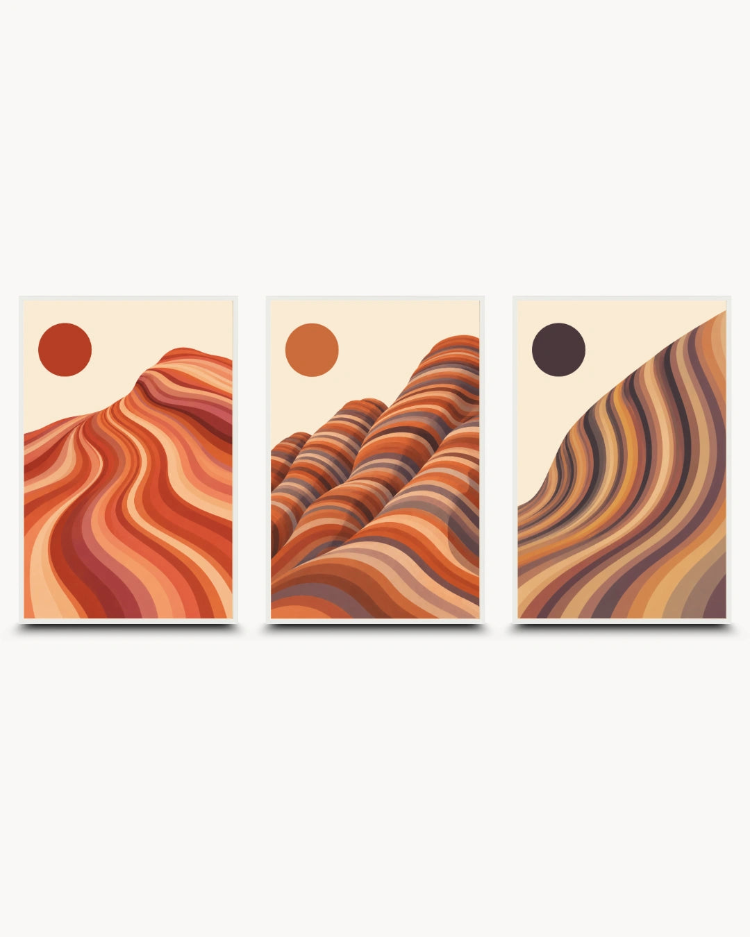 A set of three vertical abstract art prints with desert-like wavy forms and circular sun motifs in warm earth tones, shown against a light gray background.