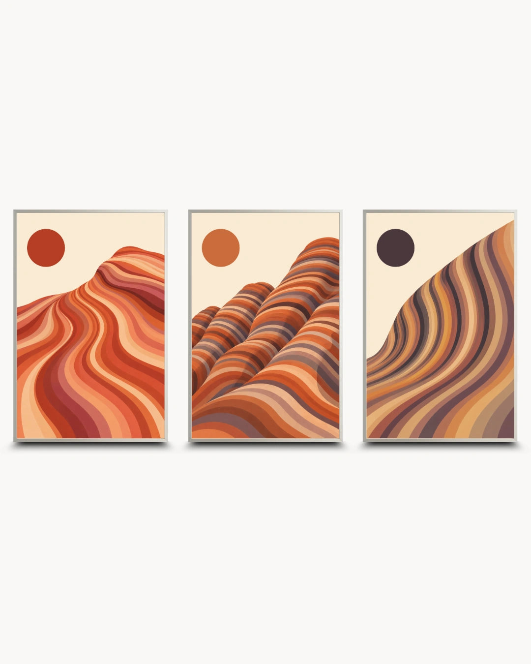 A set of three framed abstract desert landscape wall art prints in warm earth tones, featuring wavy dune-like forms and circular sun motifs on a light background.