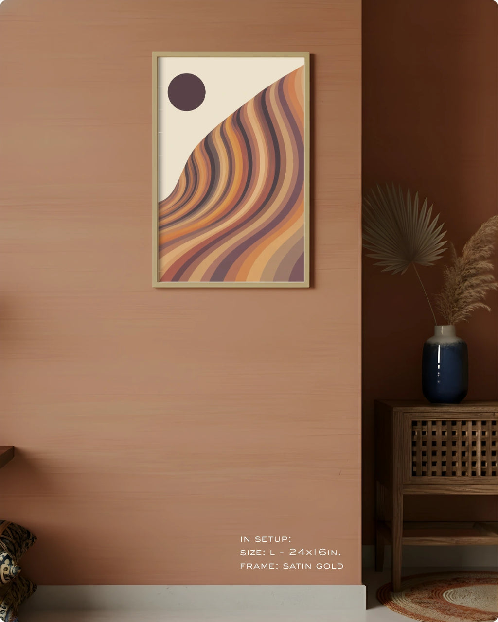 A framed abstract art print with wavy curved stripes in beige, orange, brown, and purple tones, hanging on a warm terracotta wall in a styled interior setting with a side table and vase.