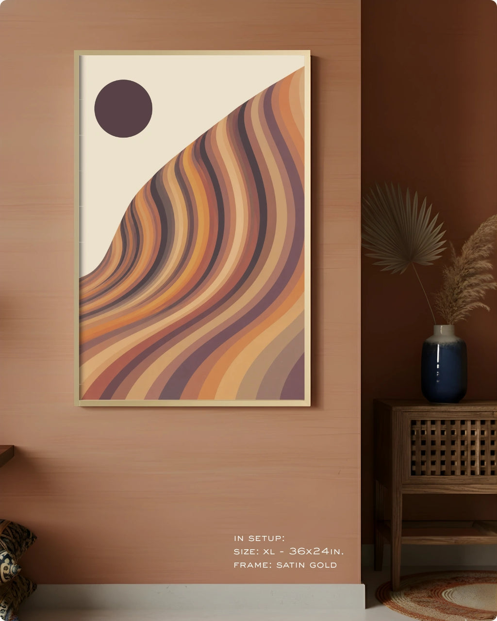 A framed abstract wall art print hangs on a warm wood wall in a styled interior. The artwork features flowing curved stripes in tan, orange, brown, and muted purple on an off-white background, with a dark oval near the top left.