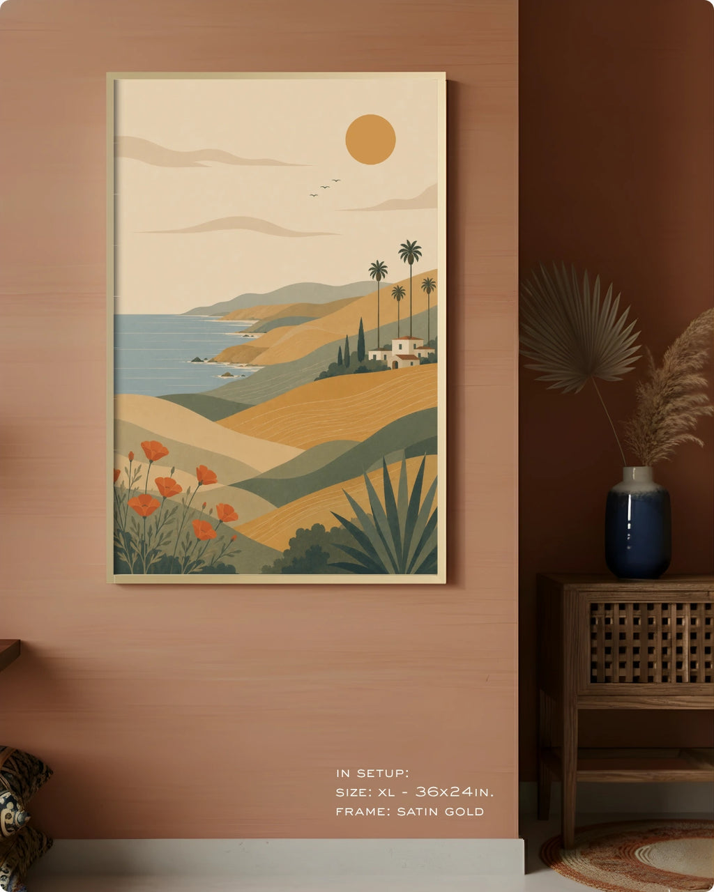A framed art print depicting a retro-style coastal landscape with rolling hills, palm trees, a blue sea, and a sun, displayed on a warm terracotta wall in a styled interior setting.