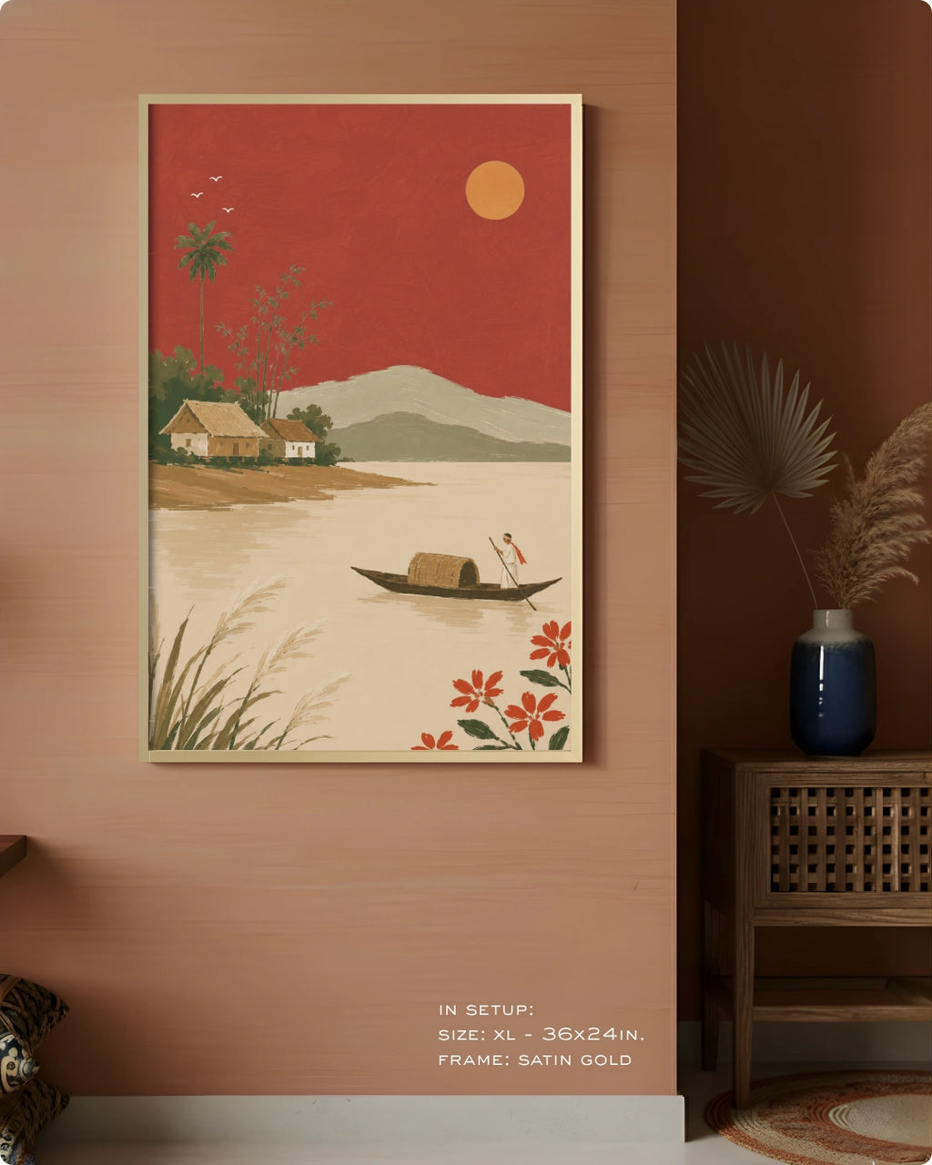 A framed art print featuring a retro-style landscape with a red sky, beige water, a small boat, and a house, displayed on a warm terracotta wall in a styled interior setting.