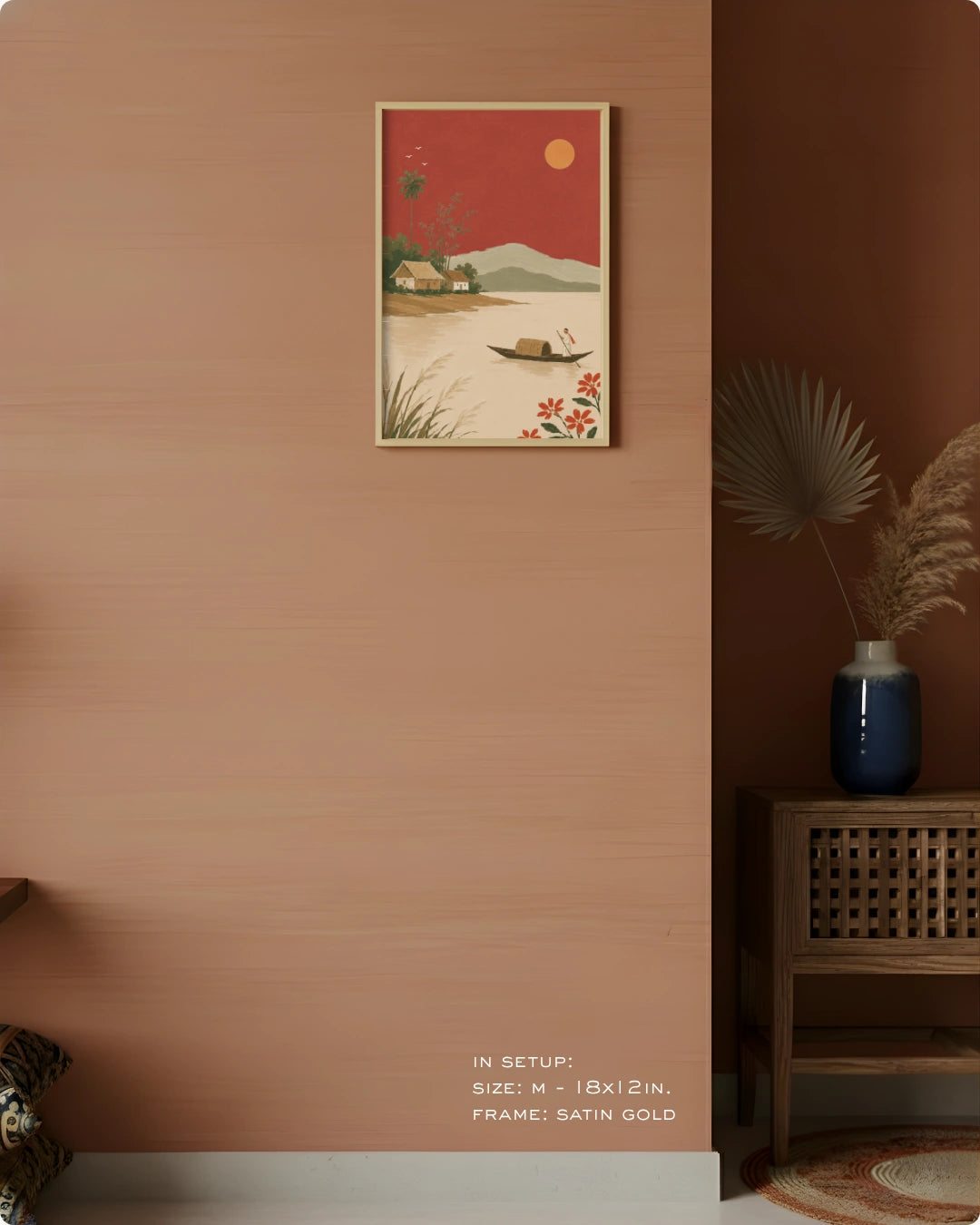 A framed art print featuring a retro-style landscape with a red sky, mountains, and a boat, displayed on a warm terracotta wall in a styled interior setting.