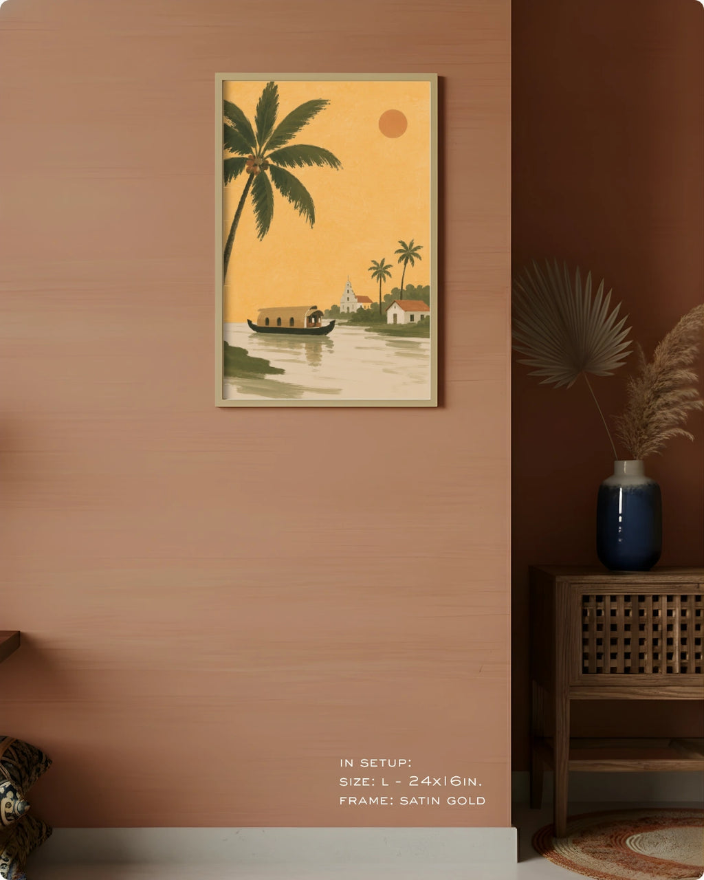 A framed vertical art print featuring a tropical sunset scene with palm trees, a houseboat, and a small boat on calm water, displayed on a warm peach wall in a styled interior setting.