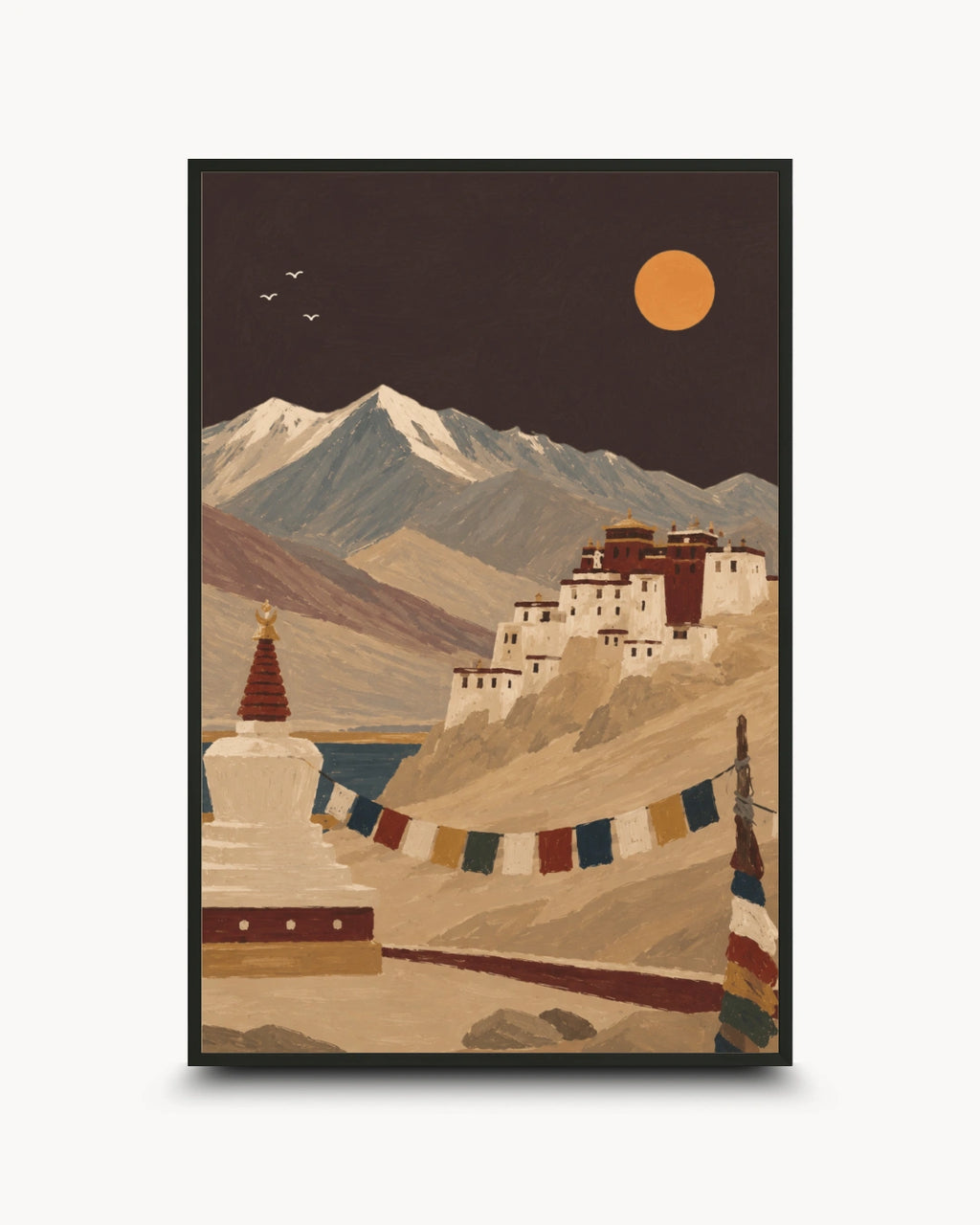 A framed art print depicting a scenic landscape with snow-capped mountains, a monastery on a hillside, a stupa in the foreground, and a large orange sun in a dark sky, shown against a light gray background.