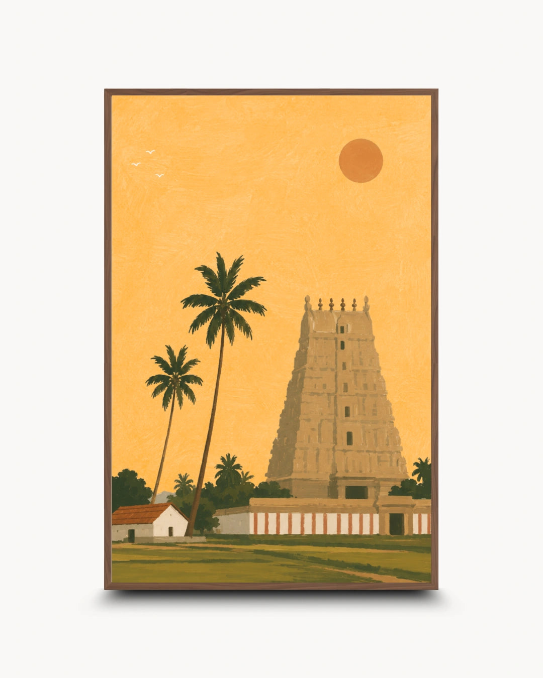 A framed art print featuring a stylized illustration of a South Indian temple tower, palm trees, a small house, and a sun against a warm golden-yellow sky, shown on a light gray background.