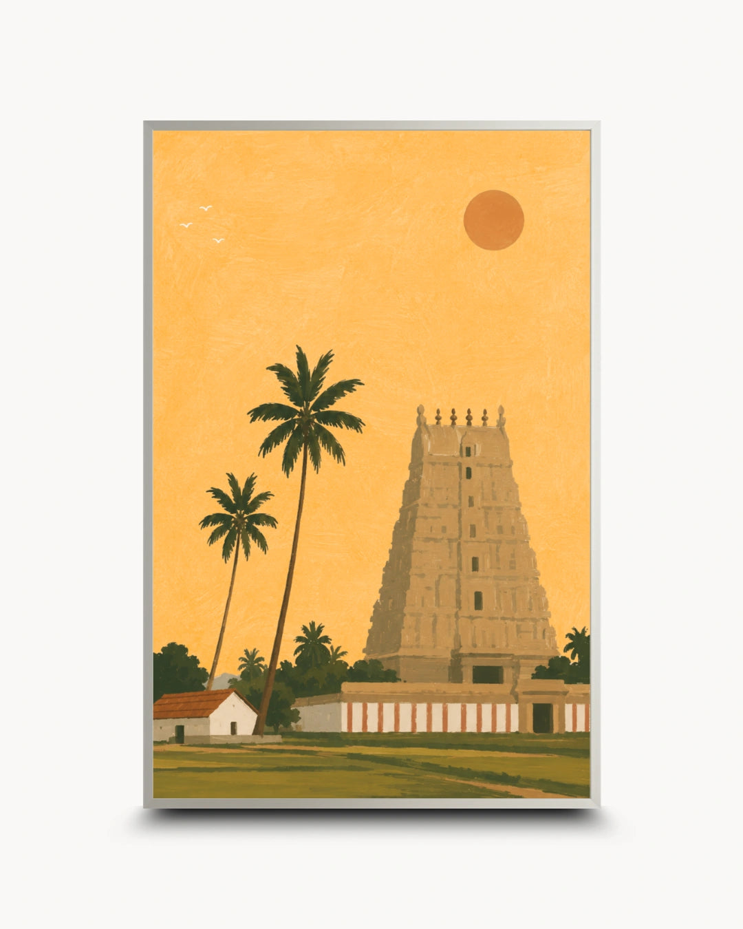 A framed art print featuring a stylized illustration of a South Indian temple tower, palm trees, a small house, and a sun against a warm golden-yellow sky, shown on a light gray background.